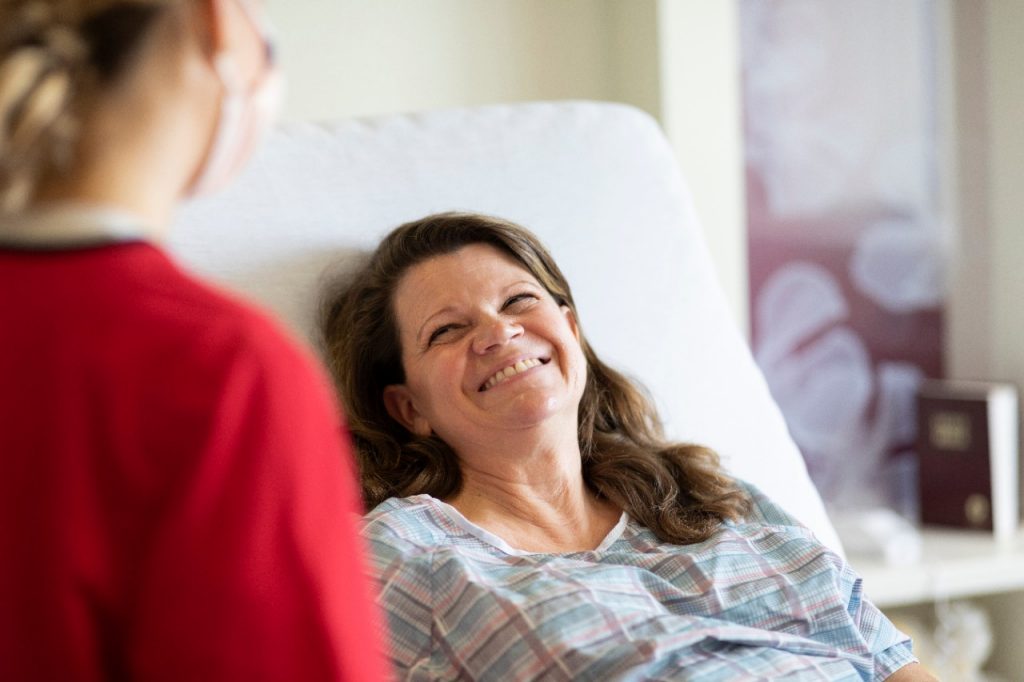 Patient smiling at a co-worker