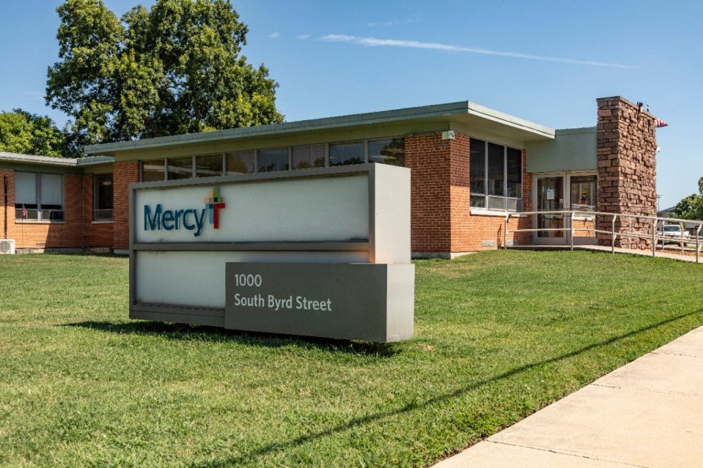 Exterior photo of the Mercy logo and sign outside Mercy Hospital Tishomingo