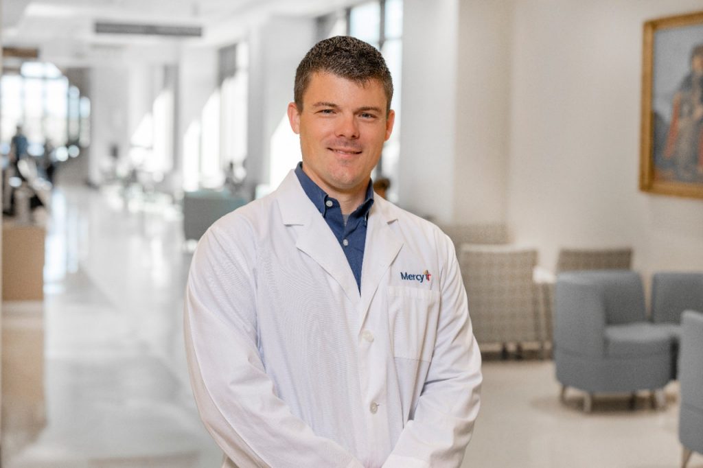 A photo of a Mercy caregiver in a white lab coat.