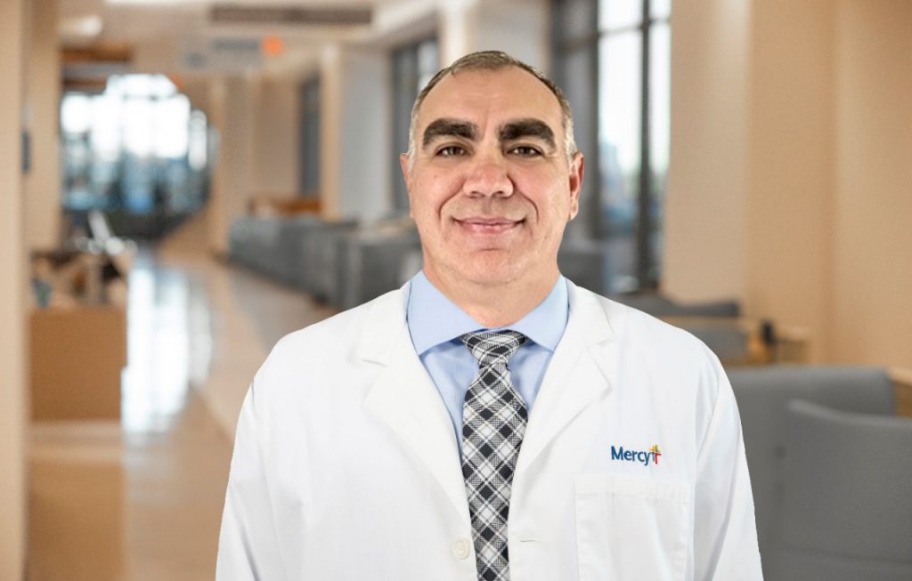 Photo from chest up of Dr. Anthony Waldroup in a white lab coat