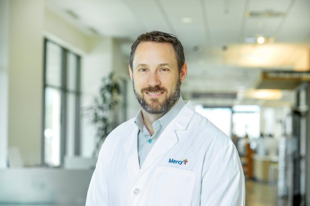 Head shot of Dr. Lance Watson wearing a white lab coat