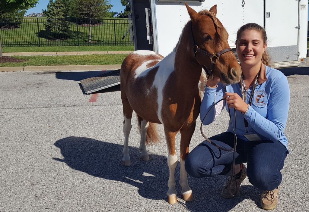 AppleJack poses with Emily Hoffman, founder of AppleJack Therapy, before visiting Mercy Kids.