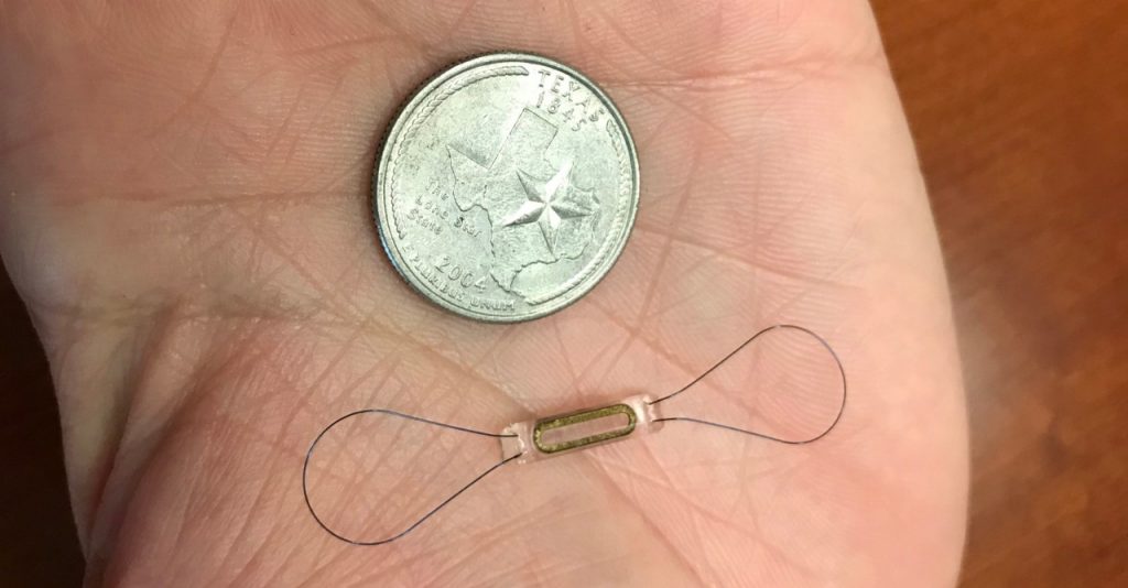 The CardioMEMS™ device is tiny and implanted into a patient's pulmonary artery. Here, it's compared to a quarter. 