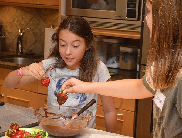 Madeline Batz and Sophie Kassel had the fun job of dipping the chocolate-covered strawberries.