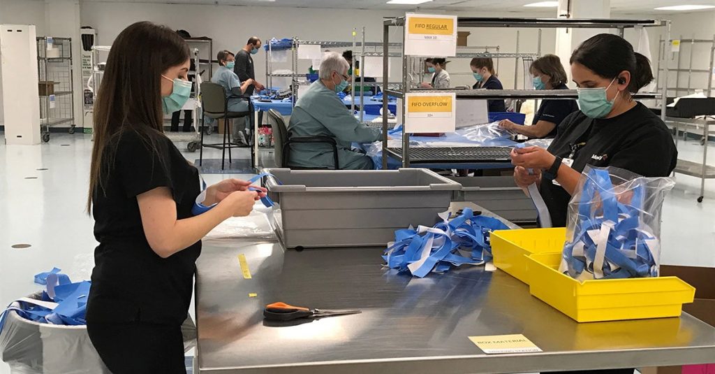 Mercy co-workers assemble face shields for use across a four-state area.