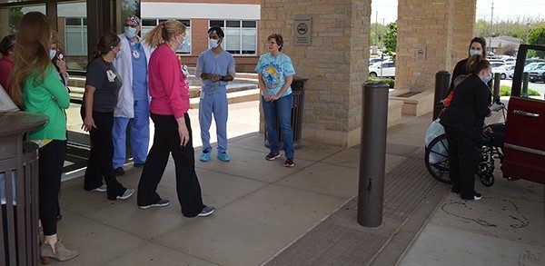 Ellen Bridgewater meets some of her husband's caregivers for the first time. Visitor restrictions during the COVID-19 pandemic limit access for families to patients.