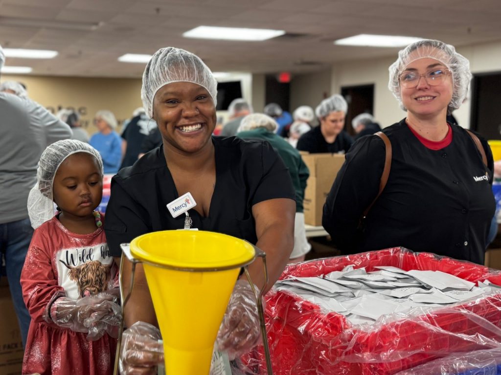A group of Mercy caregivers filling meal kits with shelf-stable ingredients.