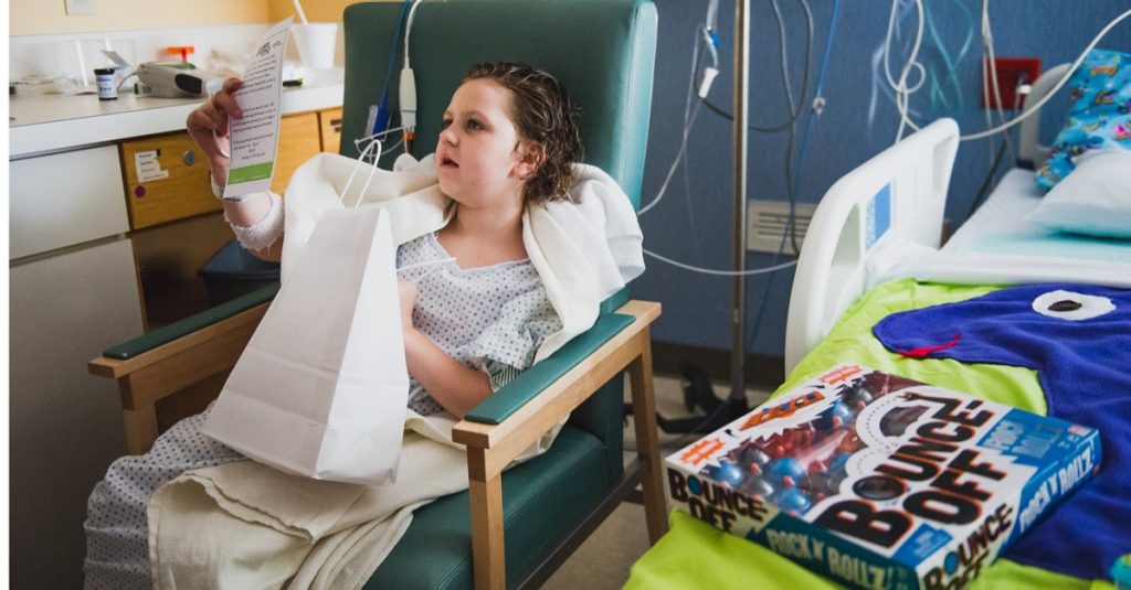 A patient at Mercy Kids children's hospital in Springfield, Missouri, looks through her gift bag from the Gamers Give Back tour.