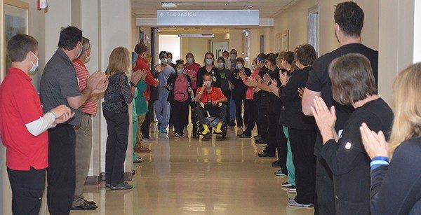 Mercy co-workers lined the hallway from the Intensive Care Unit to applaud the discharge of COVID-19 patient Terry Bridgewater.