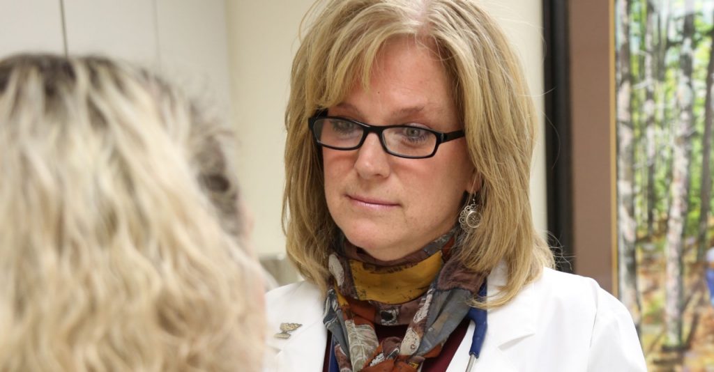 Dr. Jennifer McNay listens to a patient's health concerns.
