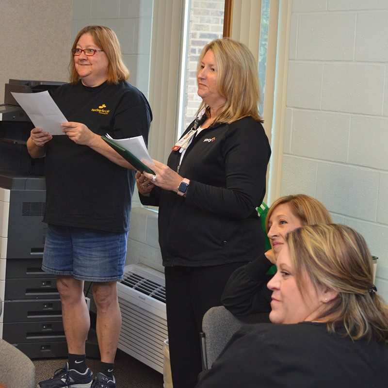 Karen Rieger, left, reads the nomination letter she wrote to thank Sandy Laramore, RN, for her life-saving intervention.