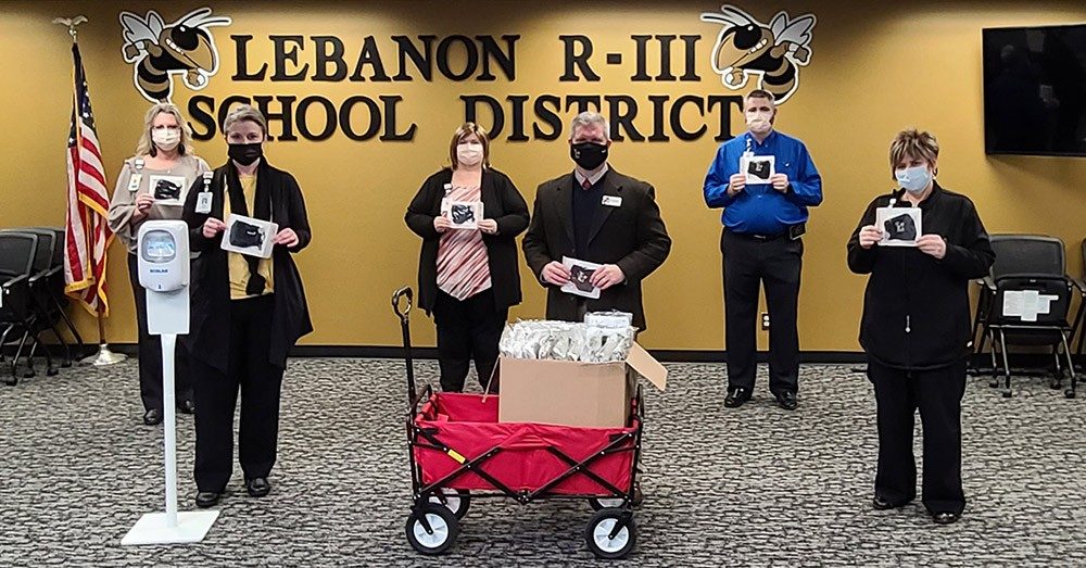 Mercy leaders present the masks and sanitizing stations to Lebanon school leaders.