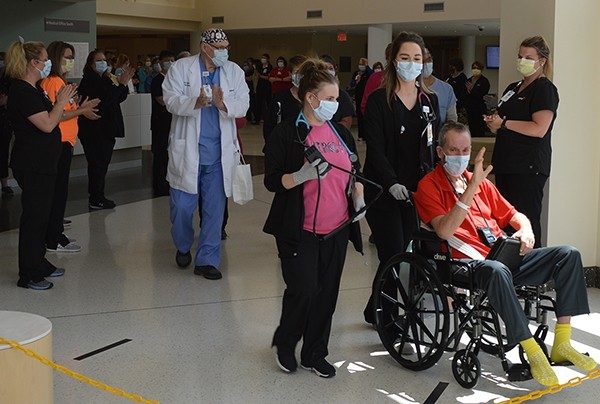 Mercy Jefferson co-workers cheer for patient Terry Bridgewater as he is escorted to the Main Entrance.  