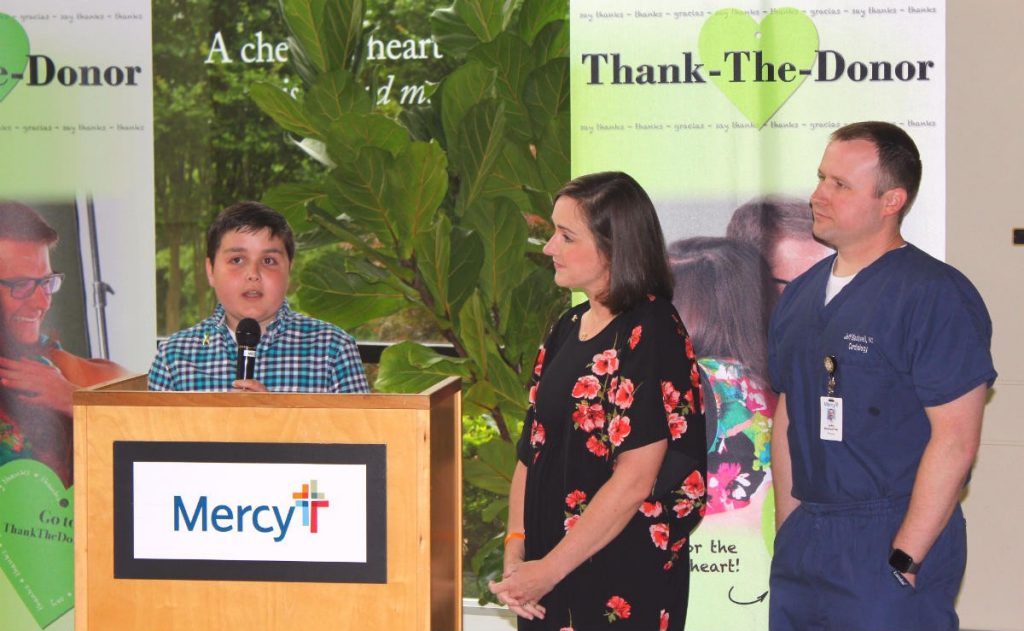 Max Blackwell, 11, a cancer survivor, talks about how a blood donation helped his recovery during a presentation May 9 at Mercy Medical Building in Fort Smith. With Max are his mother, Dee, and father, Dr. Jeffry Blackwell, a Mercy cardiologist.