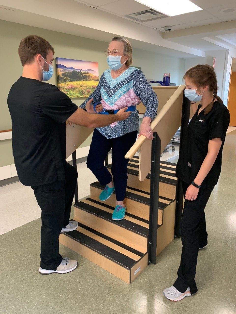 Physical Therapist Houston Talmage, left, and Occupational Therapist Allison Grant, right, work with patient Beverly Fleeger in the Mercy Hospital Northwest Arkansas inpatient rehabilitation unit.