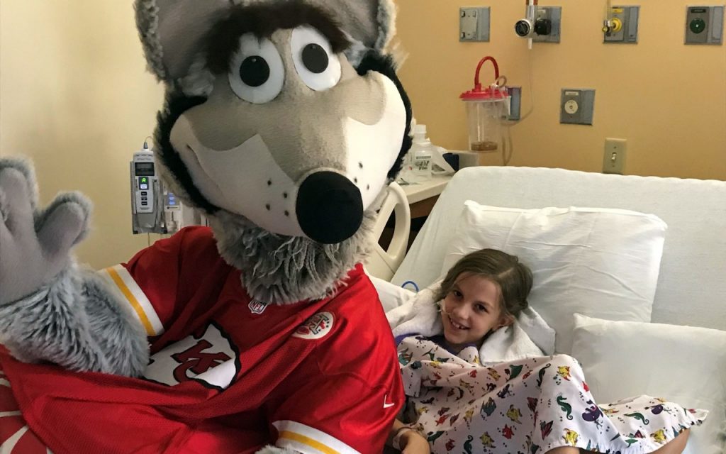 KC Wolf, mascot for the Kansas City Chiefs, gets a giggle from a patient at Mercy Kids in Springfield, Missouri.