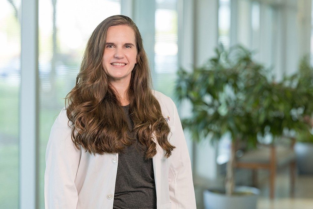 Dr. Amber Pinson-Hilkemeyer, Mercy endocrinologist, wearing a white lab coat with a Mercy logo