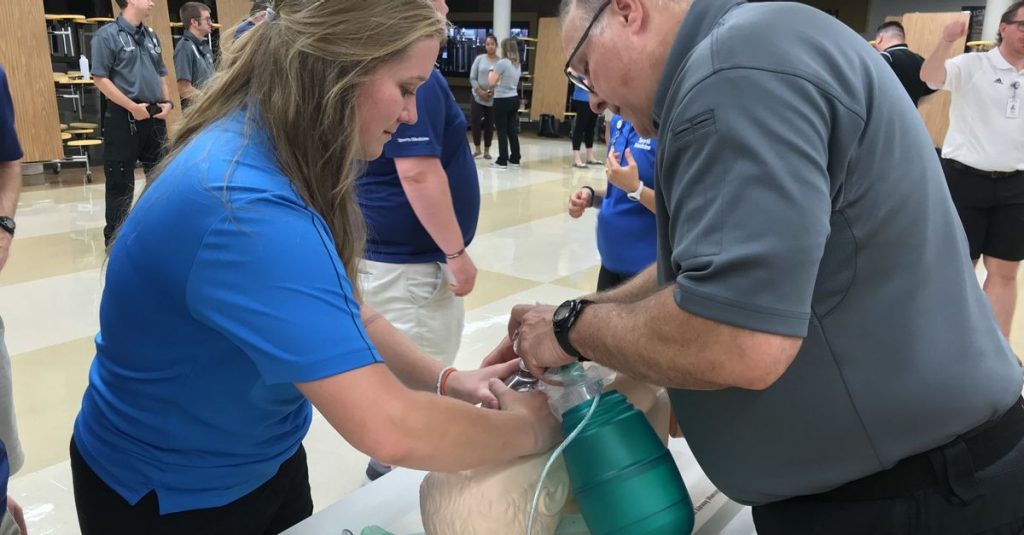 A Mercy Sports Medicine athletic trainer practices opening an athlete's airway.