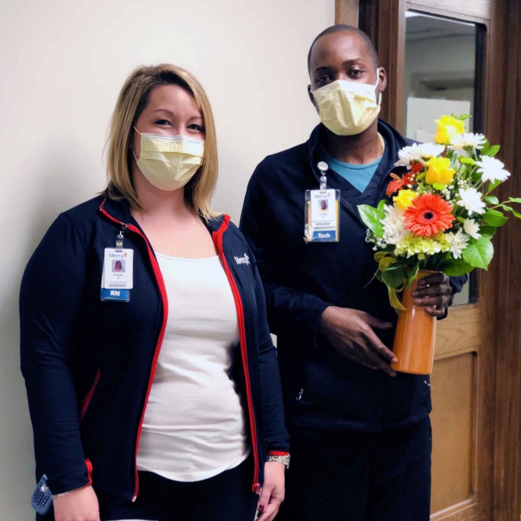 Kristin Eveland (left), nurse manager at Hyland Behavioral Health Center, and Curtis Sanders (right), behavioral health tech, celebrate Sanders earning the latest Daffodil Award for the outstanding, compassionate care at Mercy Hospital South.
