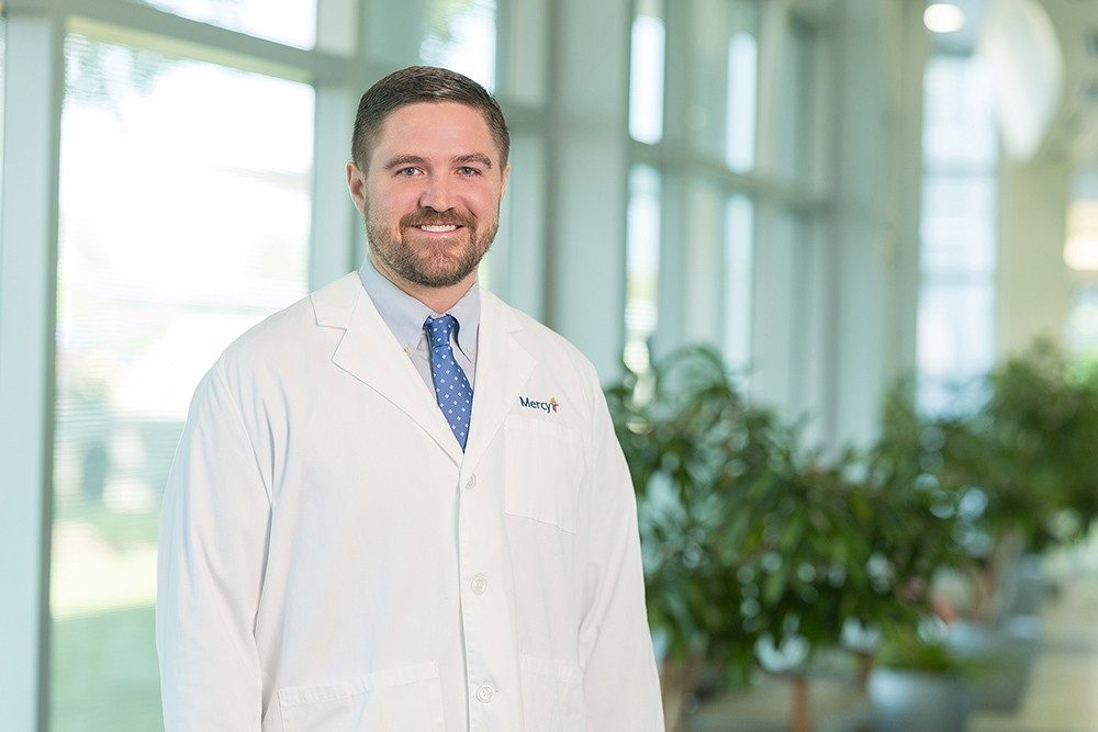 Dr. Kevin Brennan, family medicine physician, in a white lab coat with a Mercy logo