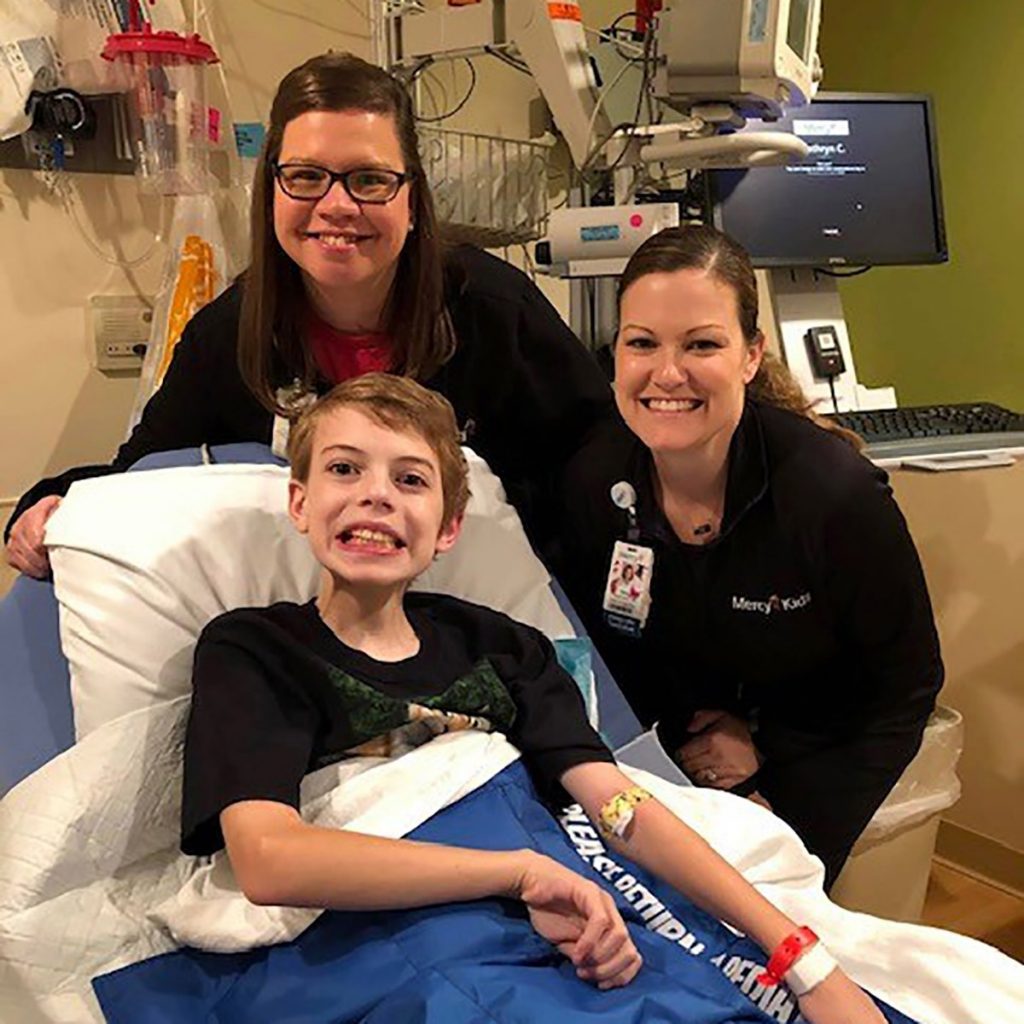 Frankie poses with Catherine (Katie) Coleman, RN and Tara Anders, child life specialist, before his procedure.