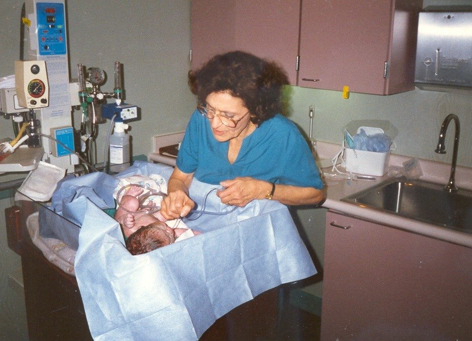 Nurse Madalene Smith caring for a newborn at Mercy Hospital Oklahoma City in 1974.