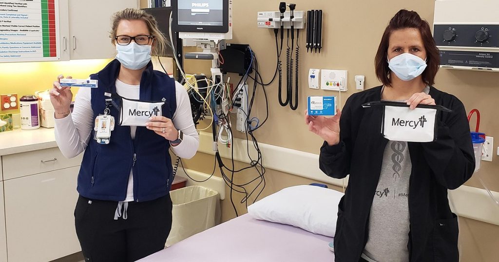 Mercy Hospital Lincoln ER nurses Deb Garnto and Emily Mudd display the COVID Care @ Home kit.