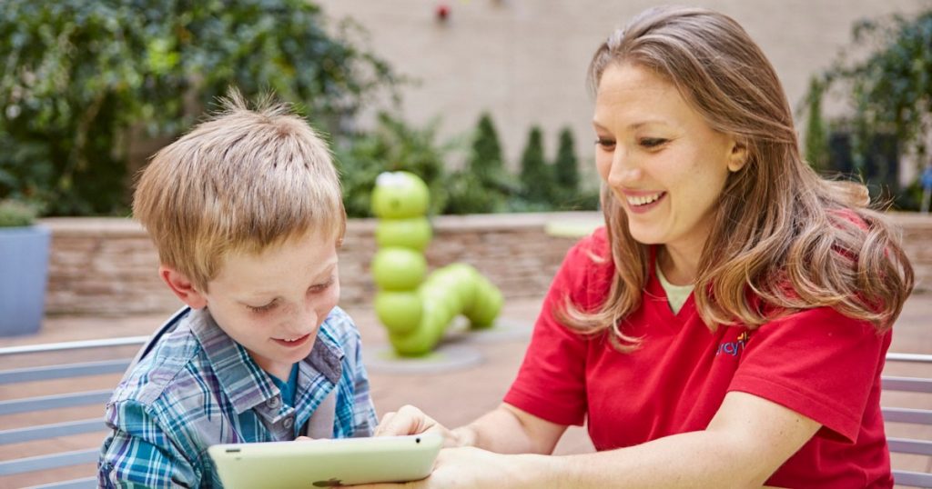 Certified Child Life Specialist Ali Stewart works with a young patient at Mercy Children's Hospital.