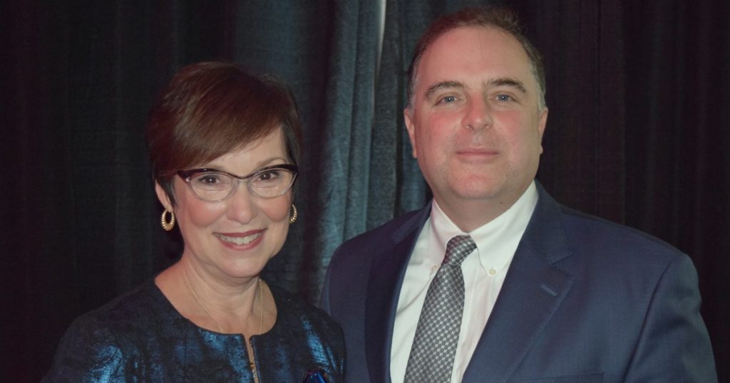 Fran Hixson, director of Clinical Quality, and Peter Brawer, Ph.D., vice president of Clinical Quality and Patient Safety for Mercy accept the Aim for Excellence Award.