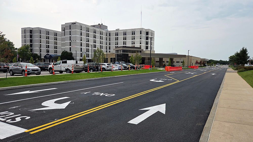 A freshly paved and newly striped road runs past Mercy Hospital South and the emergency department construction site on the Mercy South campus.
