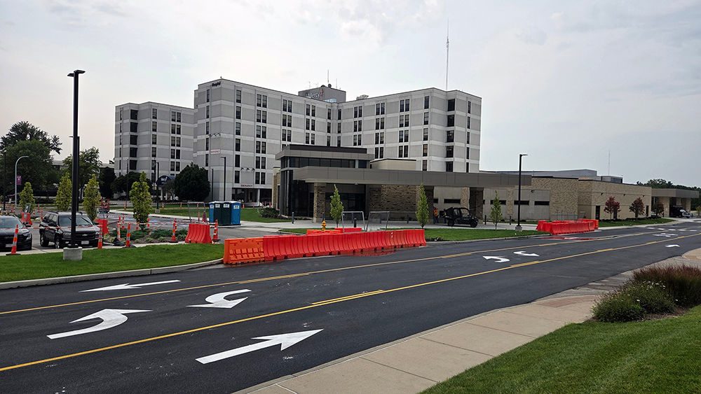 A freshly paved and newly striped road runs past Mercy Hospital South and the emergency department construction site on the Mercy South campus.