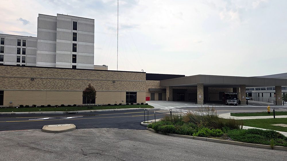 A freshly paved and newly striped road runs past the ambulance bay at Mercy Hospital South.