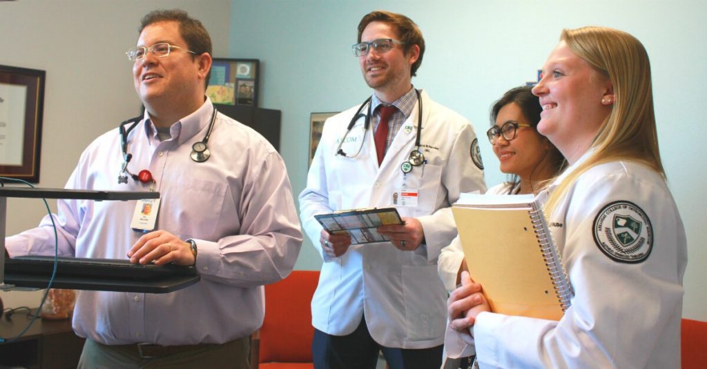 Dr. Patricio Montiel works with students from the Arkansas College of Osteopathic Medicine at the Mercy Fort Smith Hope Campus. [Photo courtesy ACHE]