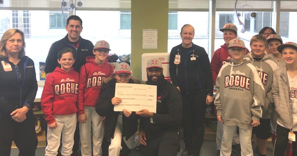 Mercy Kids pediatric staff accepts the donation from the St. Louis Rogue baseball club.