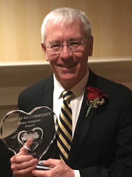 Tom Edelstein, Vice President of Mission at Mercy Hospital South, holds the Green Initiative Award received by Mercy.