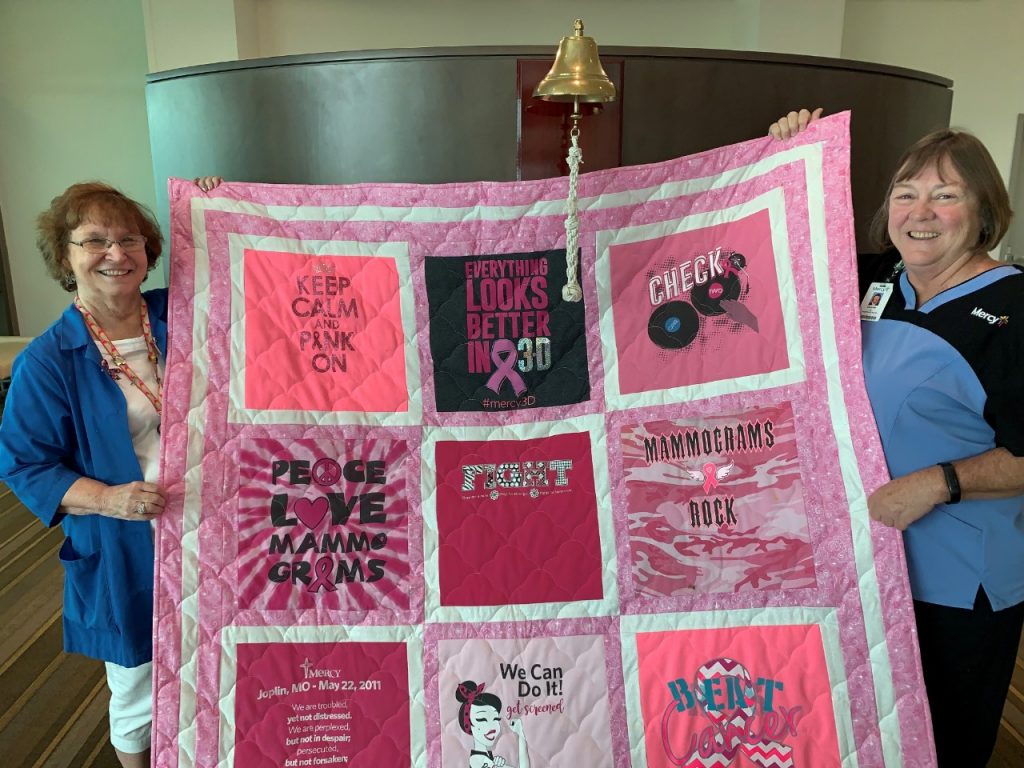 Marie Judd (left) made a quilt that will be raffled off to raise money for Mercy Hospital Joplin's oncology patient assistance program out of t-shirts donated by nurse Charlene Campbell (right).