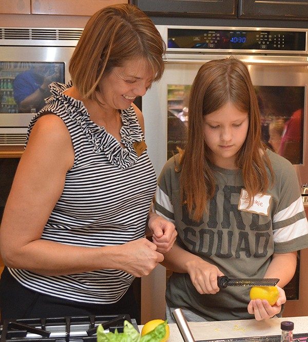 Jessica Kassel watches closely as her daughter Sophie zests a lemon during their Kids in the Kitchen class specifically for parents and children living with Type 1 Diabetes.