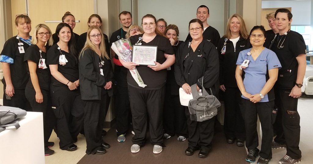 Pictured with her medical/surgery floor co-workers, Abby McClain displays her Tulip Award.