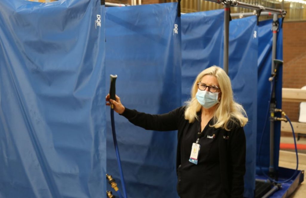 Linda Nelson demonstrates Mercy Fort Smith's new decontamination showers.