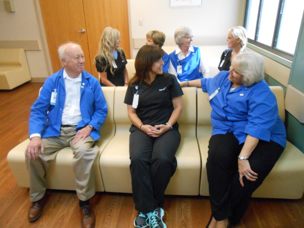  The Behavioral Health staff and auxiliary enjoying the new chairs in the behavioral health patient group room. 
