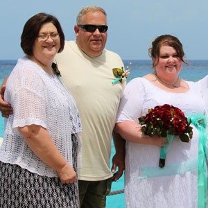 Allen (far right) with her parents on her wedding day.
