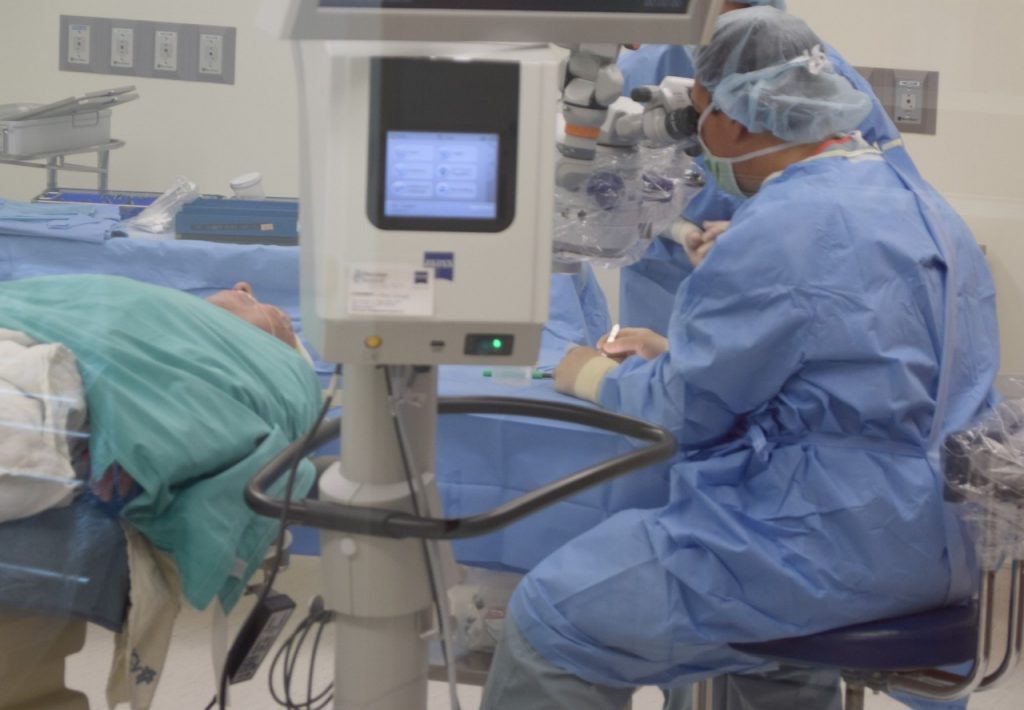 Dr. Shachar Tauber, Mercy ophthalmologist, prepares a donated cornea for implantation.