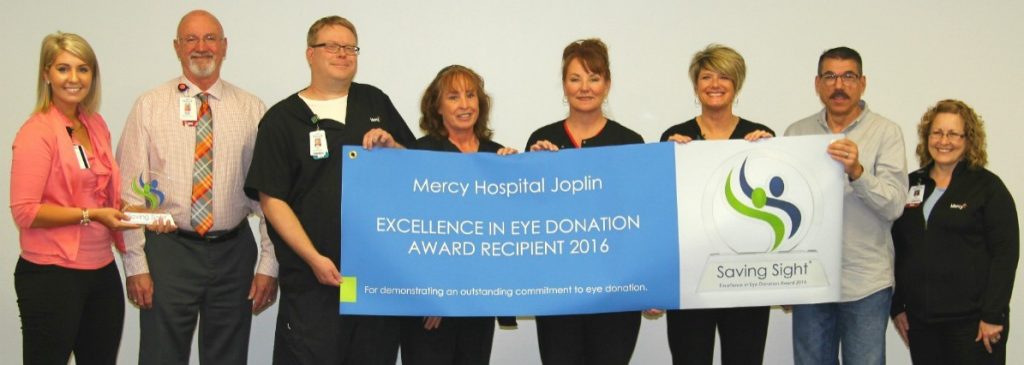 Haley Lyne (far left) of Saving Sight presents the Excellence in Eye Donation Award to Dennis Manley (second from left), chief nursing officer of Mercy Hospital Joplin.