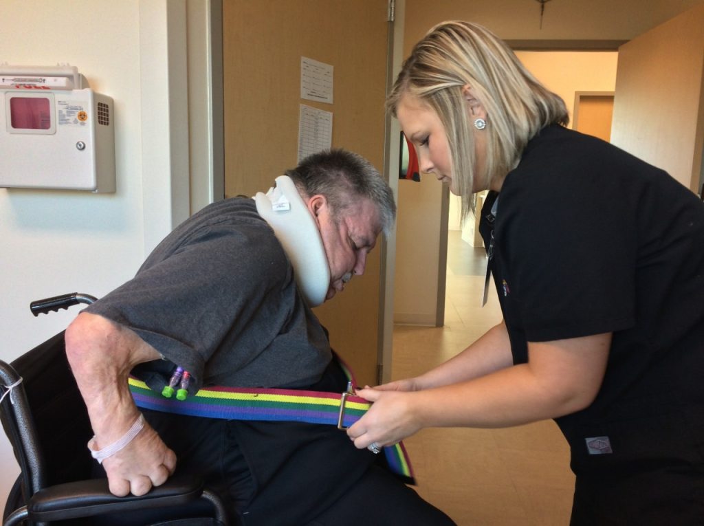 Patient Greg Redfern receives help getting up from a wheelchair. After a stay at Mercy Rehabilitation Hospital Springfield, he is once again able to walk.