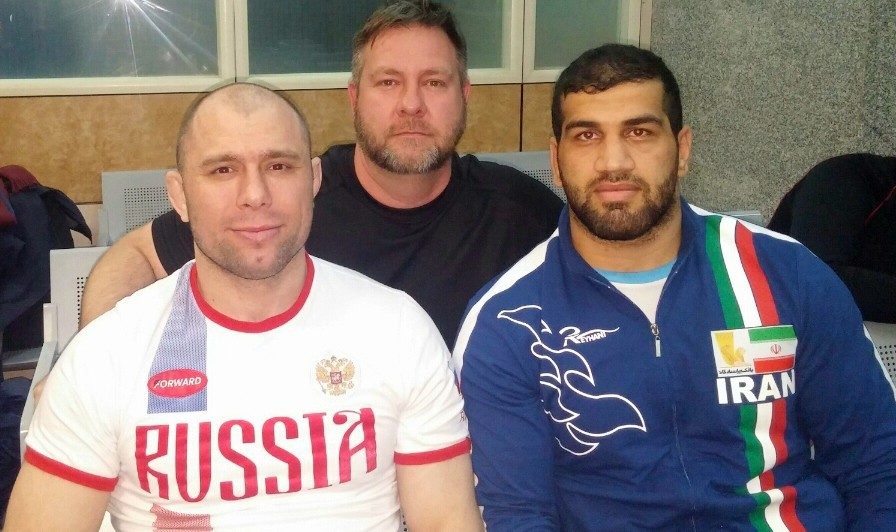 Ryan Palmer is with Khetag Gazyumov, left, a retired Russian and Azerbaijani wrestler who won 12 world and Olympic medals, and Jaber Sadeghzadeh, a back-up Iranian heavyweight for the tournament.
