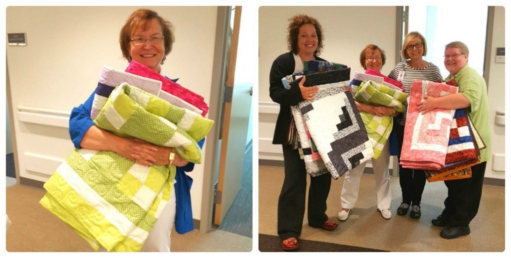 Volunteer Marie Judd (left) of the Mercy Cancer Center holds up sevearal of the quilts she made and donated. Helping Marie show off all of the quilts (from left) are Allison Odell, social worker; Rita Glaze, nurse navigator; and Jan Brown, patient access representative.
