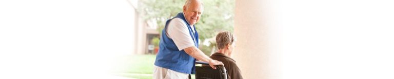 hospital volunteer wheeling out a patient