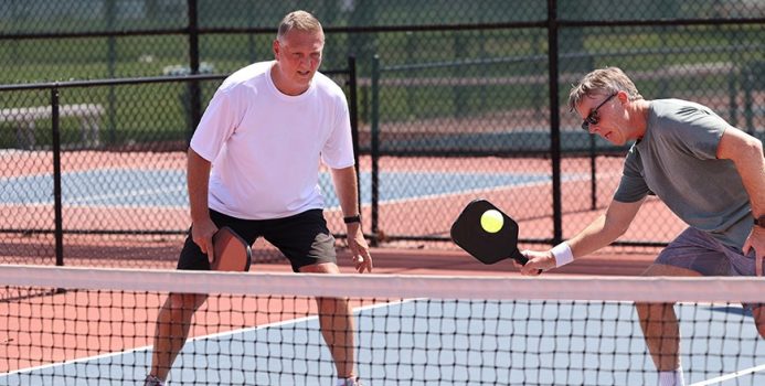 senior men playing pickleball