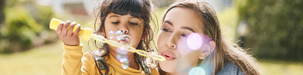Woman and child blowing bubbles